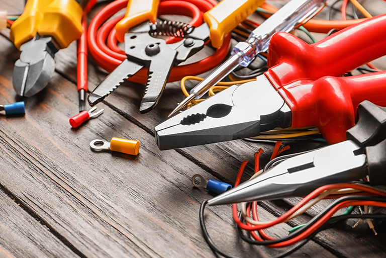 Various electrical tools laid out on table